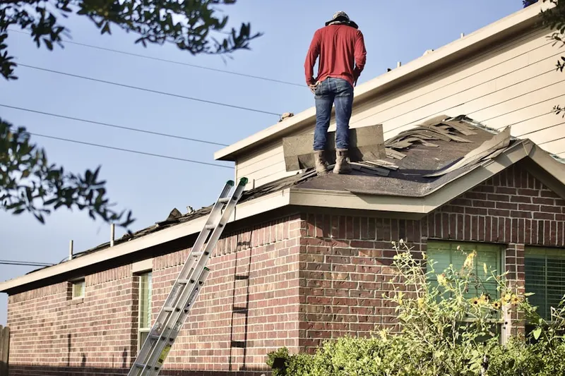 Professional roofer working on a residential roof in Brickton